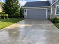 A freshly washed driveway leading to a garage